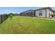 Wide green lawn and a screened pool, creating a perfect backyard oasis at 158 Mariner Ln, Rotonda West, FL 33947