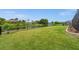 Beautiful backyard with lush green grass, a serene water view, and a sleek black fence at 158 Mariner Ln, Rotonda West, FL 33947
