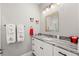 Charming bathroom with gray countertops, white cabinets, and decorative Mickey Mouse accessories at 158 Mariner Ln, Rotonda West, FL 33947