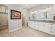 Modern bathroom with double sinks, marble counters, and tiled walk-in shower at 158 Mariner Ln, Rotonda West, FL 33947