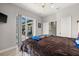 Cozy bedroom featuring a sliding glass door to the pool and outdoor living area at 158 Mariner Ln, Rotonda West, FL 33947