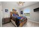Comfortable bedroom with hardwood floors, a ceiling fan, and Chicago Bears themed decor at 158 Mariner Ln, Rotonda West, FL 33947
