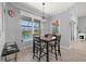 Cozy dining area with backyard pool view and decorative light fixture at 158 Mariner Ln, Rotonda West, FL 33947