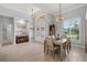 Bright dining room with a large window offering plenty of natural light and tile flooring at 158 Mariner Ln, Rotonda West, FL 33947