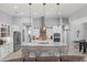 A modern kitchen boasts a large marble island, stainless steel appliances, and stylish pendant lighting at 158 Mariner Ln, Rotonda West, FL 33947