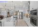 Modern kitchen with white cabinets, stainless appliances, and granite countertops at 158 Mariner Ln, Rotonda West, FL 33947