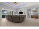 Comfortable living room with a large leather sectional sofa and a modern fireplace at 158 Mariner Ln, Rotonda West, FL 33947