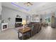 Spacious living room features a fireplace, ceiling fan, and view into dining area at 158 Mariner Ln, Rotonda West, FL 33947