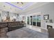 Spacious open-concept living area with fireplace, sliding glass doors to the pool, and a modern kitchen at 158 Mariner Ln, Rotonda West, FL 33947