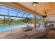 Relaxing outdoor living space with wicker furniture, a fire pit, and a pool view at 158 Mariner Ln, Rotonda West, FL 33947
