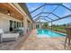 Stunning pool area with a spa, covered patio, and lush landscaping at 158 Mariner Ln, Rotonda West, FL 33947