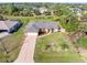 Aerial view of a well-maintained home with a spacious yard, mature trees, and a long driveway at 1909 Johannesberg Rd, North Port, FL 34288