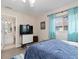 Bedroom featuring a king-size bed, en-suite bathroom, and plenty of natural light at 1909 Johannesberg Rd, North Port, FL 34288
