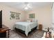 Bedroom with a full-size bed, wood floors, ceiling fan, and a well-lit window at 1909 Johannesberg Rd, North Port, FL 34288