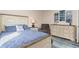 Cozy bedroom with a comfortable queen-size bed, dresser, and a neutral color scheme at 1909 Johannesberg Rd, North Port, FL 34288