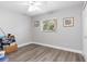 Neutral bedroom featuring a window for natural light, wood-style flooring, and a ceiling fan at 1909 Johannesberg Rd, North Port, FL 34288