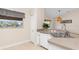 Kitchen featuring modern sink, countertops, tile flooring, and a view into dining area at 1909 Johannesberg Rd, North Port, FL 34288