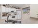 Bright kitchen with white appliances, cabinets and a neutral countertop, offering a clean and modern look at 1909 Johannesberg Rd, North Port, FL 34288