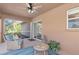 Cozy screened patio features comfortable seating and a ceiling fan for outdoor relaxation at 1909 Johannesberg Rd, North Port, FL 34288