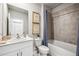 Bathroom with a white single sink vanity, matching toilet, and a bathtub with tiled backsplash at 2136 Royal Tern Cir, Punta Gorda, FL 33983