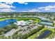Beautiful aerial showcasing community amenities including the pool, clubhouse, tennis courts, and scenic pond at 2136 Royal Tern Cir, Punta Gorda, FL 33983