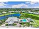 Expansive aerial view of the community pool, clubhouse, and surrounding homes, perfect for relaxation and recreation at 2136 Royal Tern Cir, Punta Gorda, FL 33983
