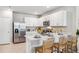 Contemporary kitchen with white cabinets, stainless steel appliances, and a cozy breakfast bar at 2136 Royal Tern Cir, Punta Gorda, FL 33983