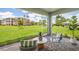 Screened lanai with outdoor seating, view of lush green lawn and tropical landscaping at 2136 Royal Tern Cir, Punta Gorda, FL 33983