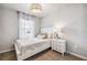 Bright bedroom features a neutral color palette, lovely light fixture, and decorative pillows at 2138 Royal Tern Cir, Punta Gorda, FL 33983