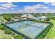 Beautiful aerial view of the tennis courts, clubhouse, and pool within this lush planned community at 2138 Royal Tern Cir, Punta Gorda, FL 33983