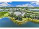 Community aerial view of the lake, clubhouse, and surrounding landscaping in this beautiful neighborhood at 2138 Royal Tern Cir, Punta Gorda, FL 33983