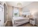 Main bedroom with neutral decor, a modern light fixture, and a view of the outdoors at 2138 Royal Tern Cir, Punta Gorda, FL 33983