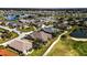 Scenic aerial view of the neighborhood, showcasing lush landscaping, water views, and community amenities at 24036 Buckingham Way, Port Charlotte, FL 33980