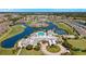 Aerial view of community featuring lake, golf course, pool, tennis courts, and well manicured grounds at 24036 Buckingham Way, Port Charlotte, FL 33980