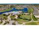 Aerial view of community featuring golf course, tennis courts, pool, and lake at 24036 Buckingham Way, Port Charlotte, FL 33980
