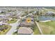 Beautiful aerial view of home in golf community with mature landscaping backing up to the course and lake at 24036 Buckingham Way, Port Charlotte, FL 33980