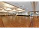 Expansive ballroom with a stage, neutral decor, and ample space for events and gatherings at 24036 Buckingham Way, Port Charlotte, FL 33980