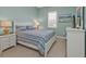 Bright bedroom features white wood furniture and an ocean themed comforter set at 24036 Buckingham Way, Port Charlotte, FL 33980