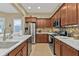 Modern kitchen features stainless steel appliances, tiled backsplash, and white quartz countertops at 24036 Buckingham Way, Port Charlotte, FL 33980