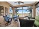 Cozy lanai featuring comfortable seating and panoramic views of the surrounding greenery and landscape at 24036 Buckingham Way, Port Charlotte, FL 33980