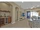 Open-concept living room with a bar area and seamless flow to the outdoor patio through sliding glass doors at 24036 Buckingham Way, Port Charlotte, FL 33980