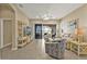 Bright living room featuring neutral tones, tile floors, and sliding glass doors leading to the outdoor living space at 24036 Buckingham Way, Port Charlotte, FL 33980