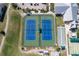 Aerial view of tennis courts in a well-maintained community with lush landscaping and nearby amenities at 24036 Buckingham Way, Port Charlotte, FL 33980