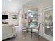 Breakfast nook featuring a glass table and chairs with a view of the pool outside the bay window at 2479 Sonoma Dr W, Nokomis, FL 34275