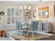 Bright dining area with natural light, showcasing a modern chandelier, and a chic rug at 2479 Sonoma Dr W, Nokomis, FL 34275