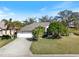 Charming single-story home featuring a two-car garage, lush landscaping, and a well-manicured lawn at 2479 Sonoma Dr W, Nokomis, FL 34275
