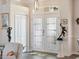 Elegant foyer with frosted glass double doors, art niche, and transom window at 2479 Sonoma Dr W, Nokomis, FL 34275