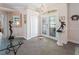 Elegant foyer featuring gray tile floors, an arched doorway, and decorative art pieces on display at 2479 Sonoma Dr W, Nokomis, FL 34275