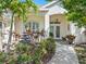 Inviting front entrance with lush landscaping, fountain, and brick walkway at 2479 Sonoma Dr W, Nokomis, FL 34275