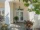 Inviting front entrance with double doors, decorative plants, and elegant architectural details at 2479 Sonoma Dr W, Nokomis, FL 34275